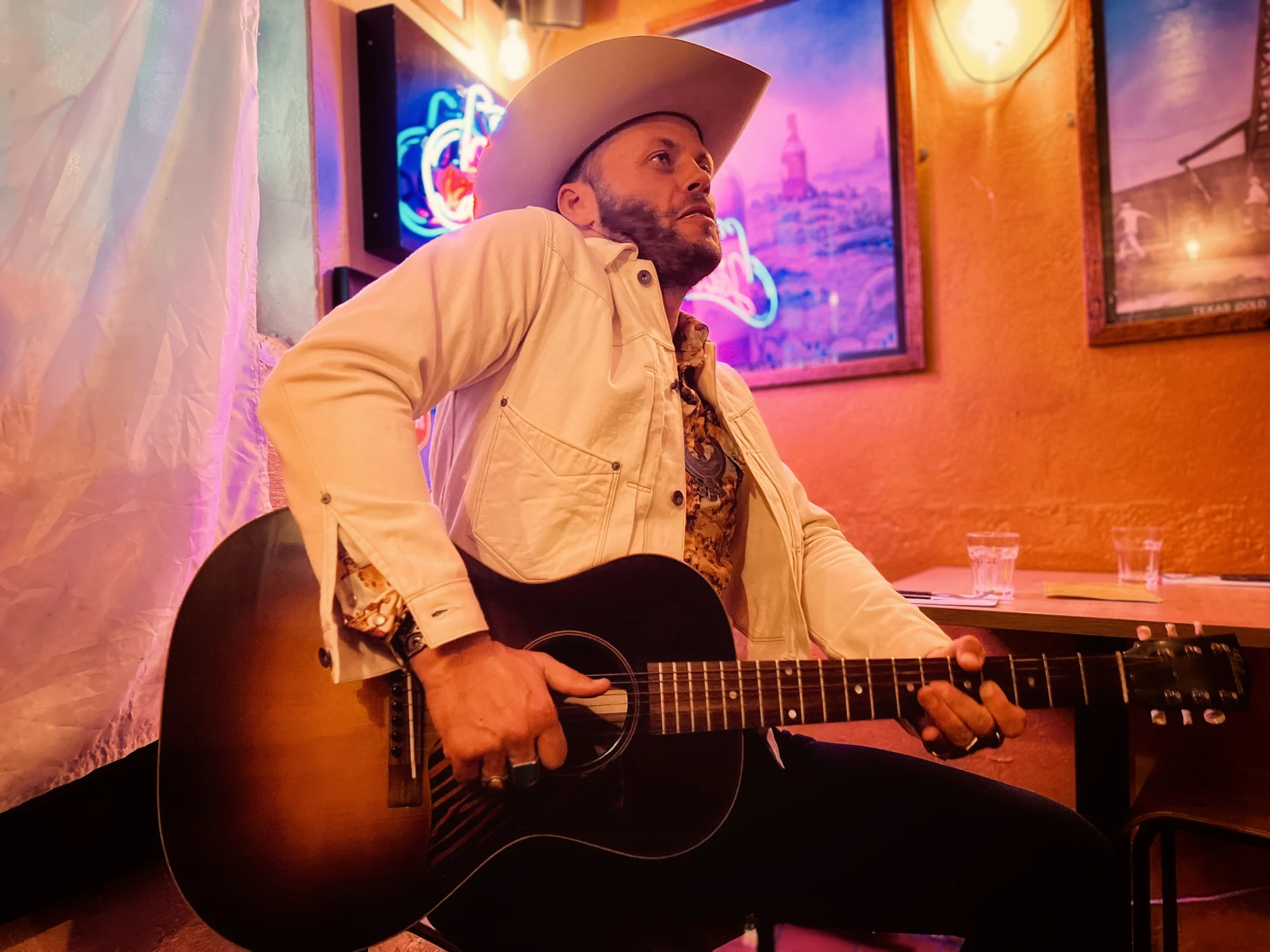 Charley Crockett playing guitar in the Flying W Saloon