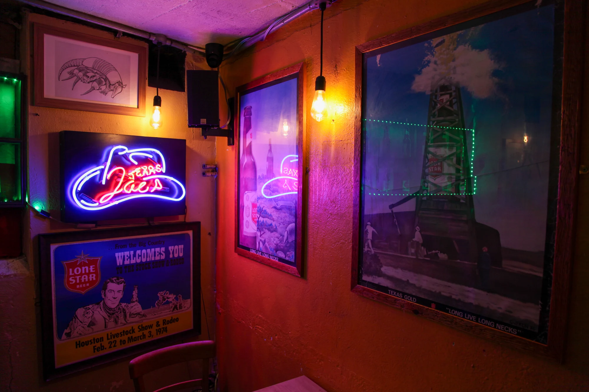 Texas Joe’s neon and framed posters in the bar