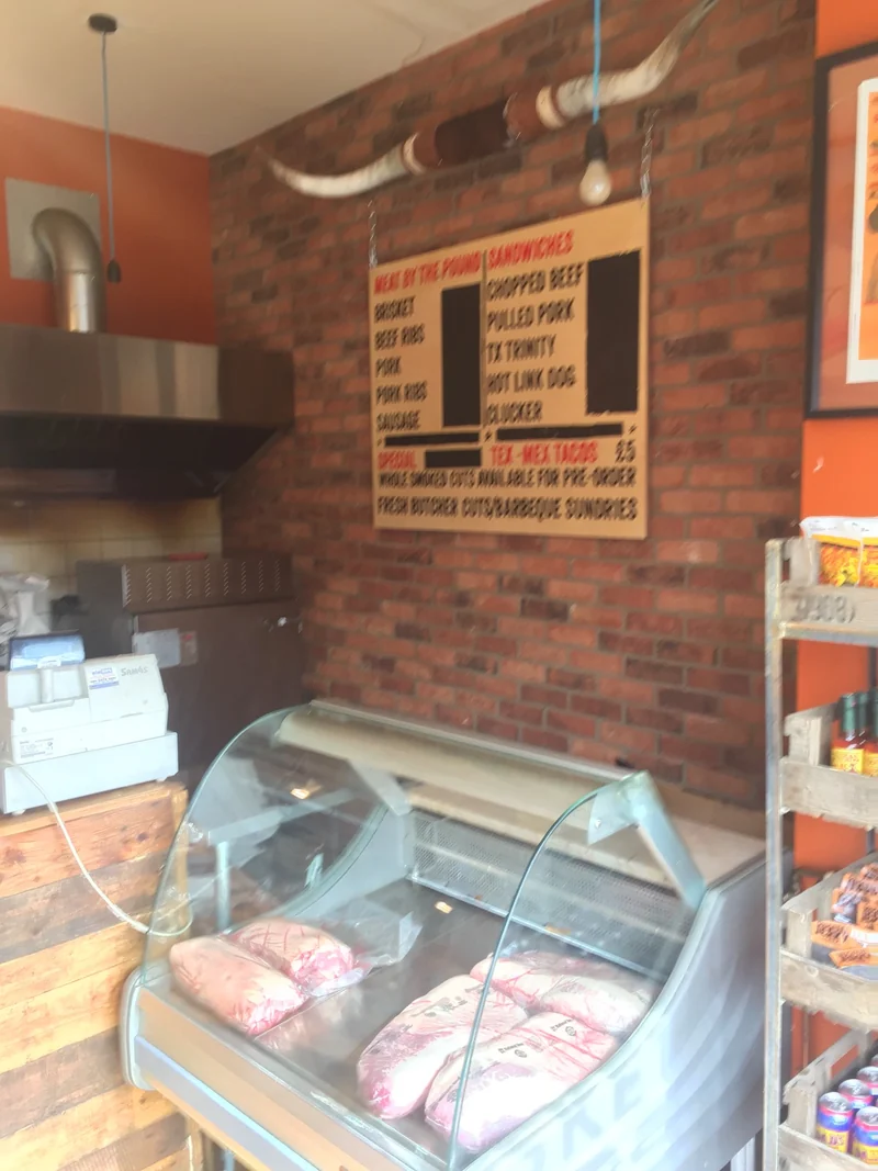 The counter, longhorn and hand-painted menu inside the Holloway Road shop
