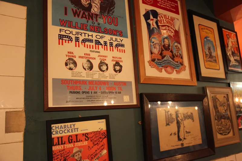 Willie Nelson concert posters and Charley Crockett’s signed poster on the Texas Joe’s walls