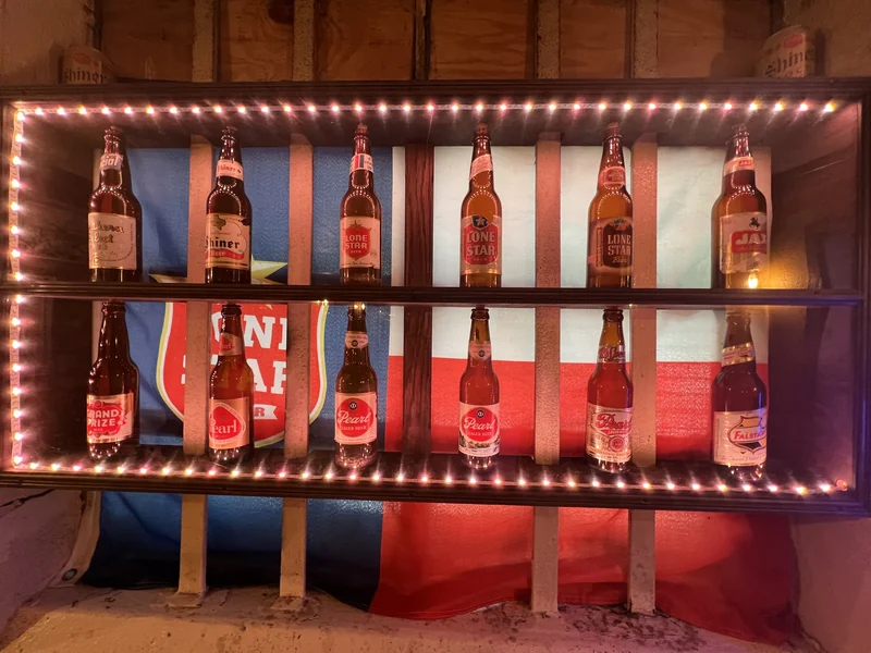 The complete wall-mounted collection of Texas beer bottles and labels