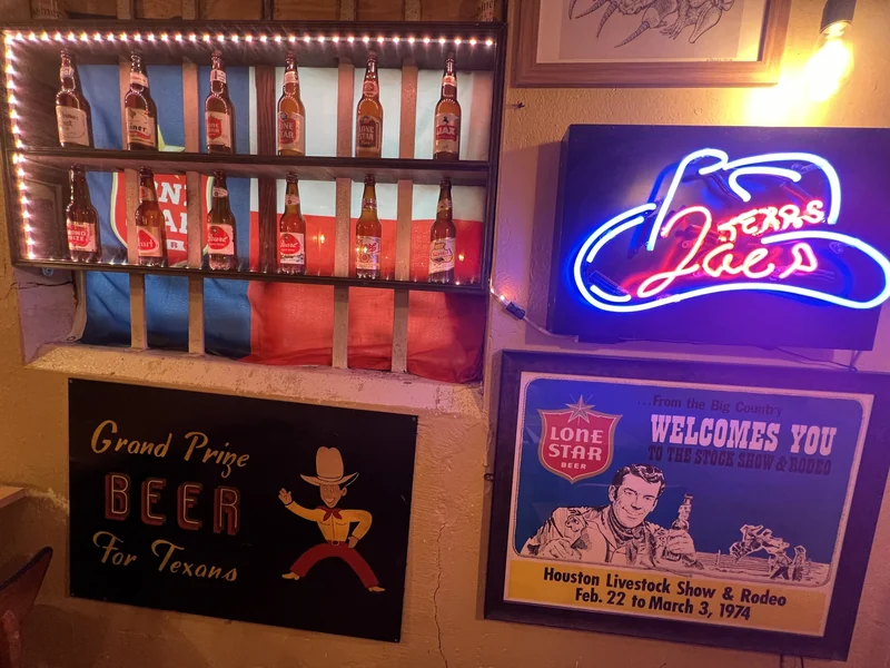 Vintage Texas beer signs, the bottle cabinet and Texas Joe’s neon in the Flying W