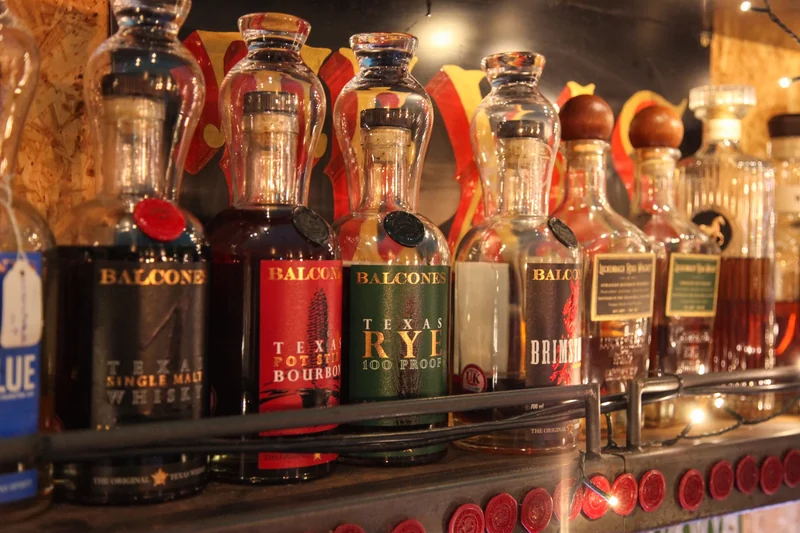 Texas whiskey bottles on the bar