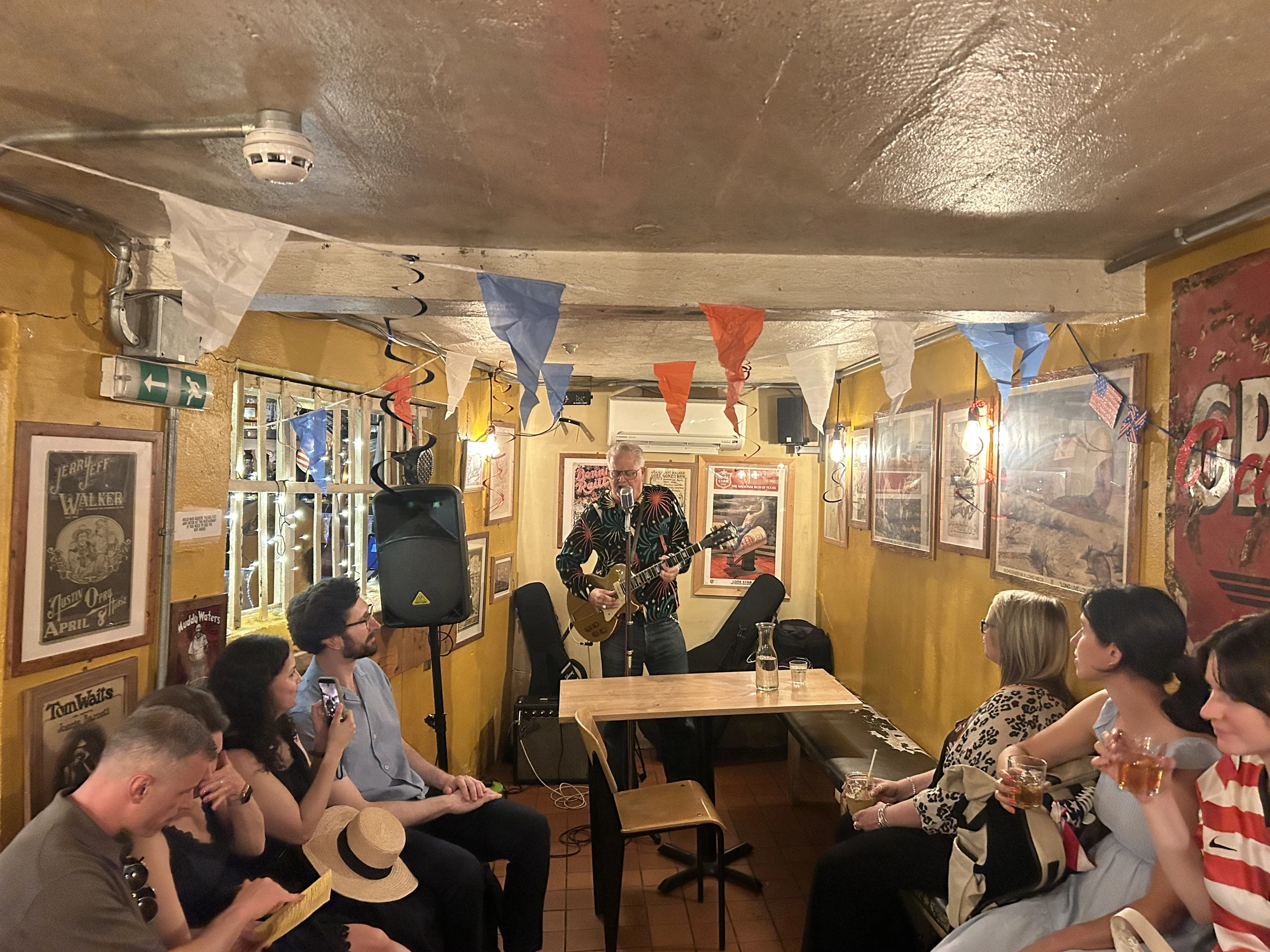 A guitarist playing to guests seated in the Flying W Saloon