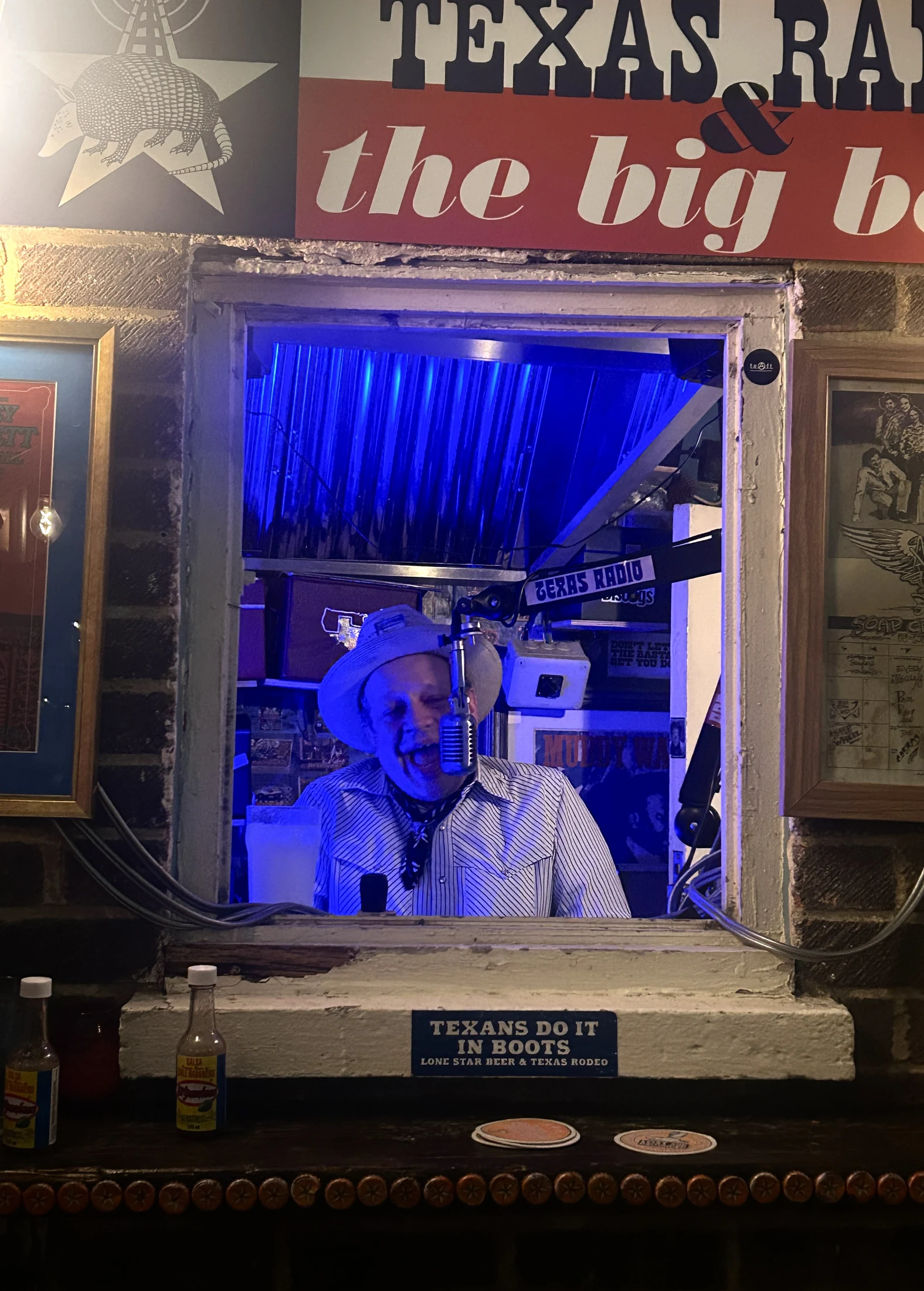 A performer at the Texas Radio booth in the Flying W Saloon