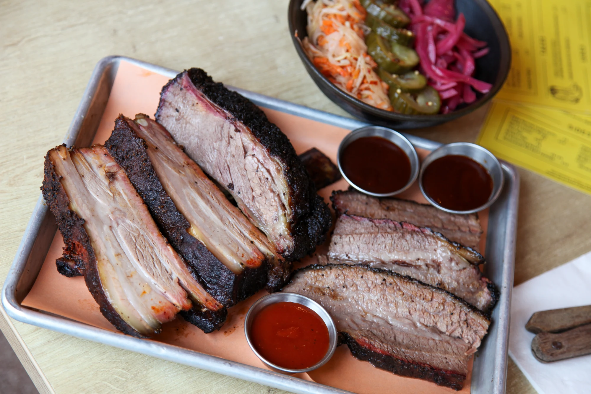 A tray of smoked meats, pickles and slaw